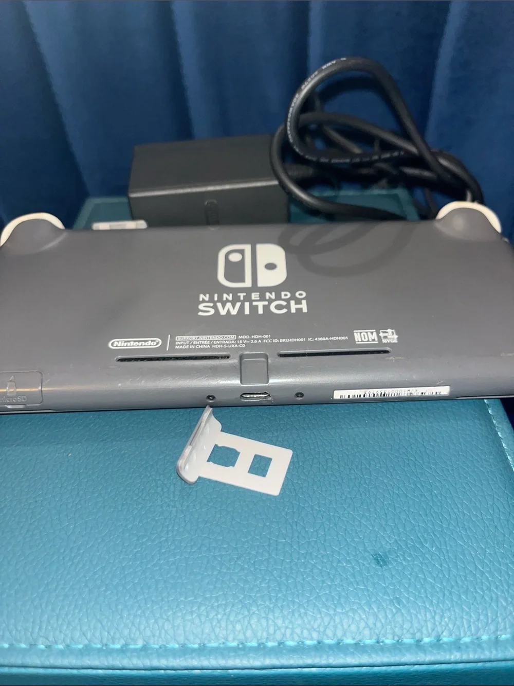 Gray and White Nintendo Switch Lite w/original Charger. Gently Used.
